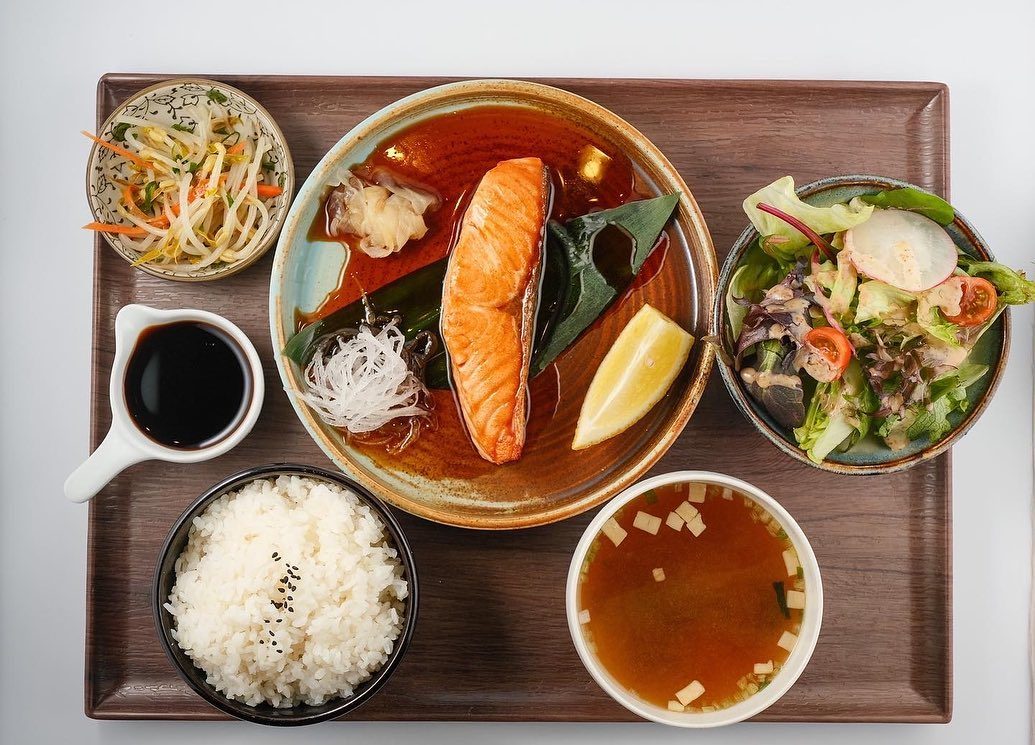 A salmon set with rice, miso soup and salad